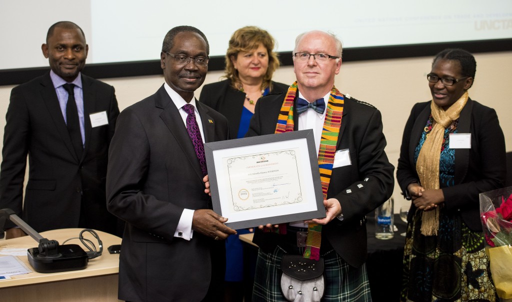 Picture shows His Excellency High Commissioner Nkwelle Ekaney of Cameroon receiving his Fellowship Certificate from Professor John Struthers with Beltus Etchu CEO of AFS, Fiorina Mugione of UNCTAD and Mrs Ekaney in the background